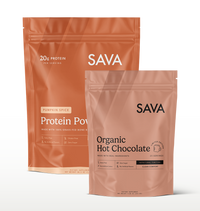 Two SAVA stand-up pouches of protein powder on a clean white background: a larger Pumpkin Spice pouch in back and a smaller Organic Hot Chocolate pouch in front.