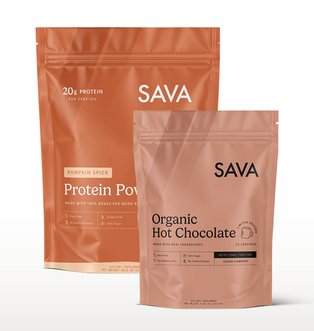 Two SAVA stand-up pouches of protein powder on a clean white background: a larger Pumpkin Spice pouch in back and a smaller Organic Hot Chocolate pouch in front.